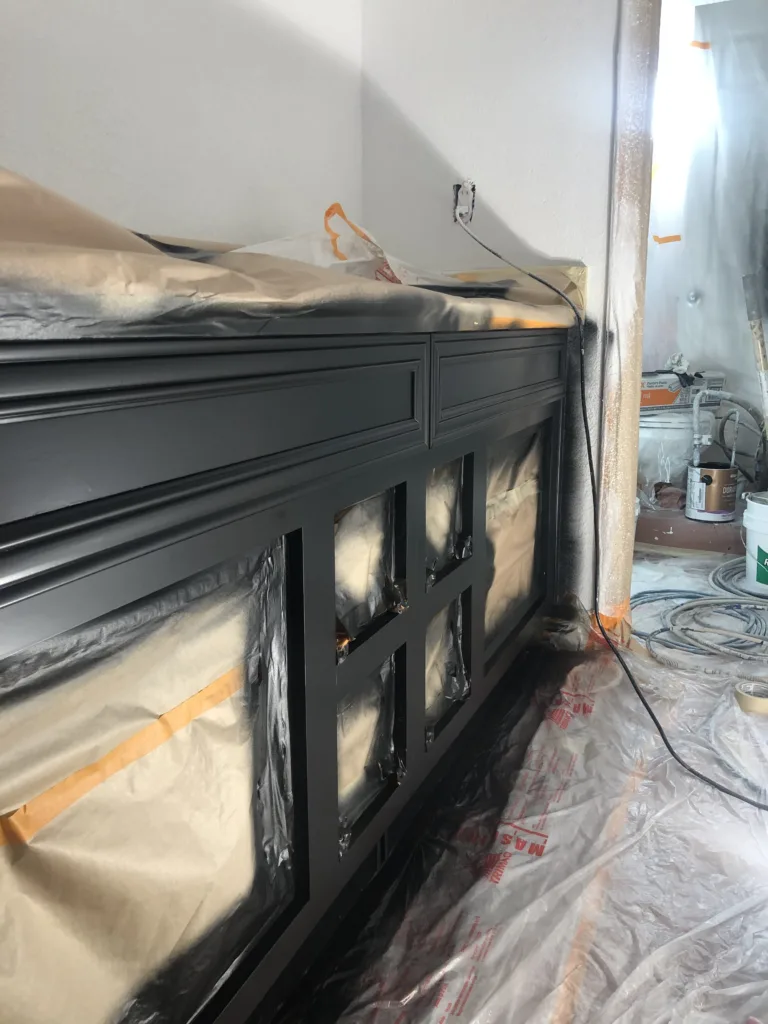 Black spray painted cabinets without doors