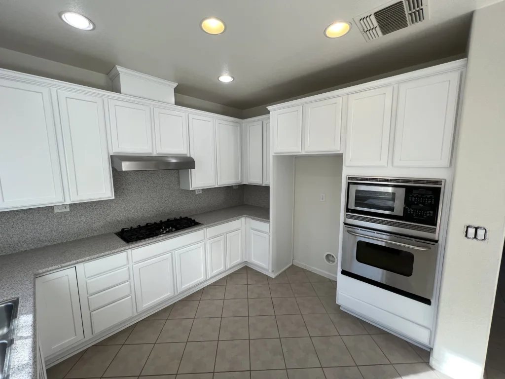 a corner view of a white painted kitchen cabinet