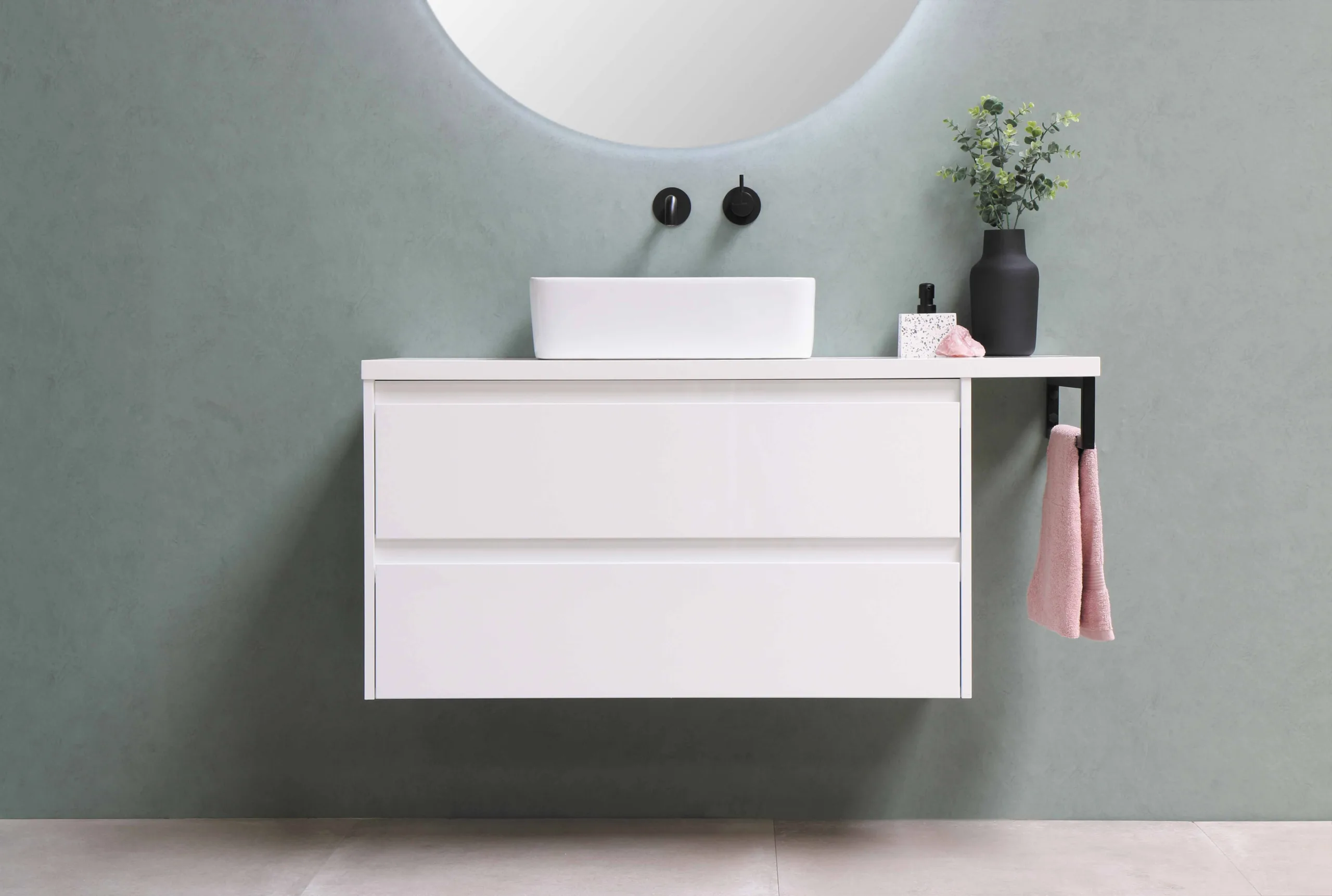 A white laminate cabinet with light blueish grey back splash