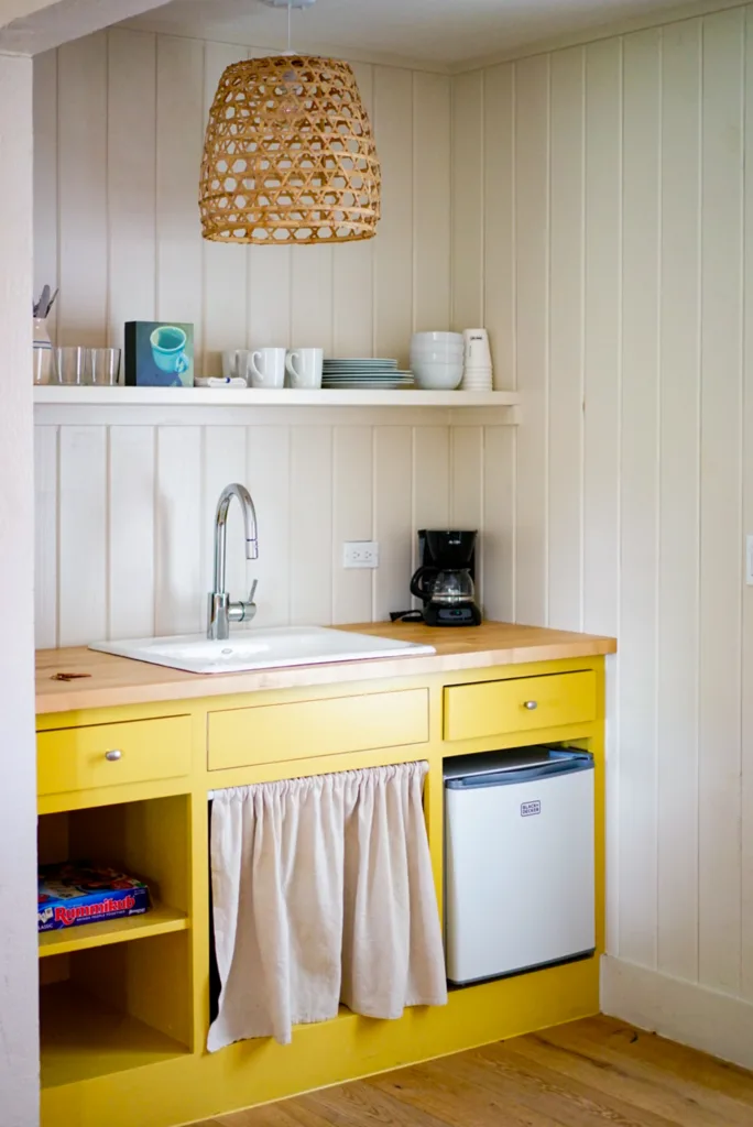 A yellow painted kitchen cabinet