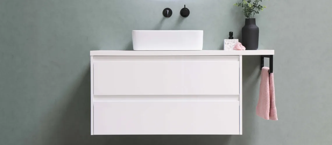 A white laminate cabinet with light blueish grey back splash